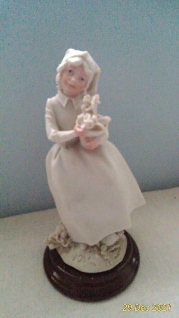 CERAMIC 'GIRL CARRYING FLOWERPOT' FIGURINE