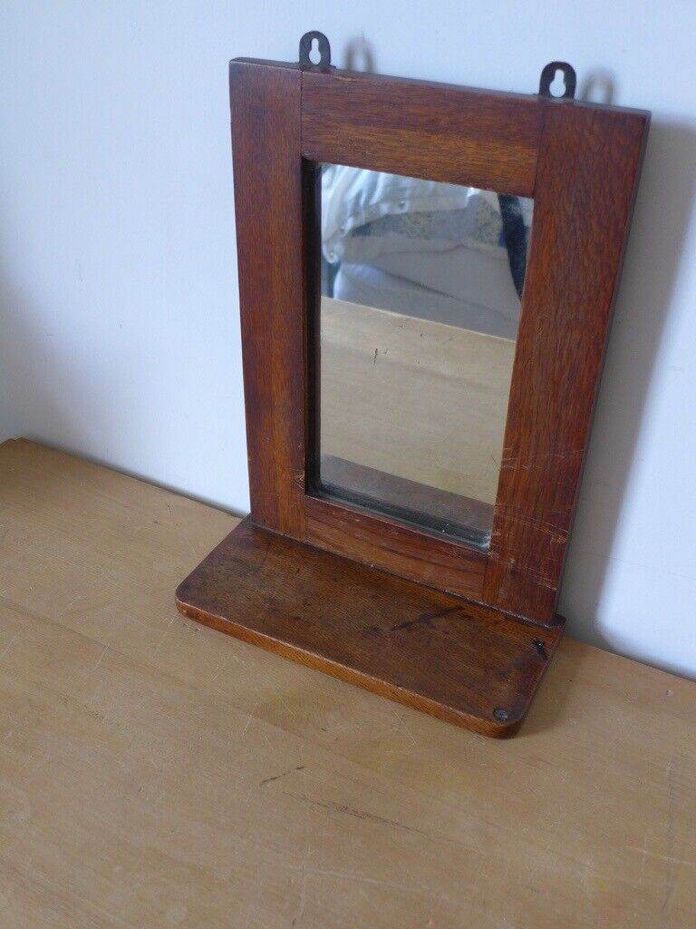 Antique vintage solid wood wall mirror with shelf. Simple, attractive design.