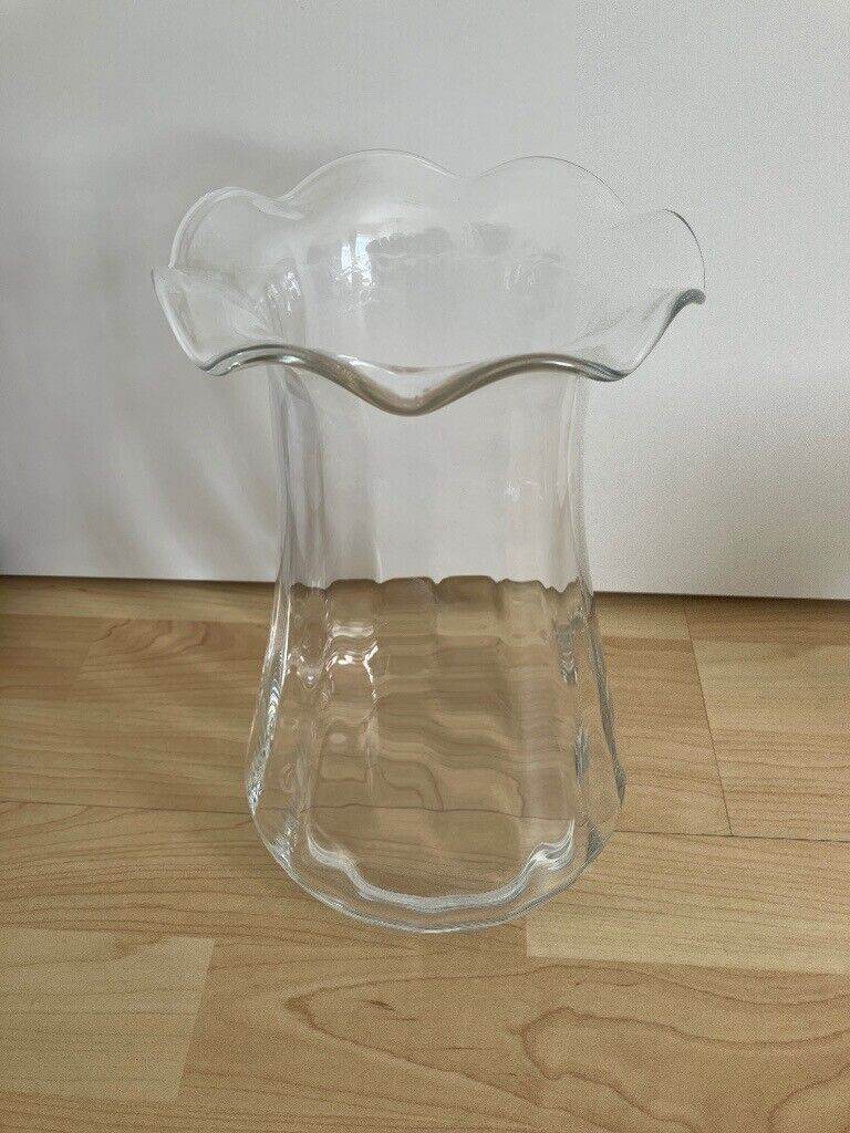 Tall glass vase with frilly/frilled/fluted neck/opening/top