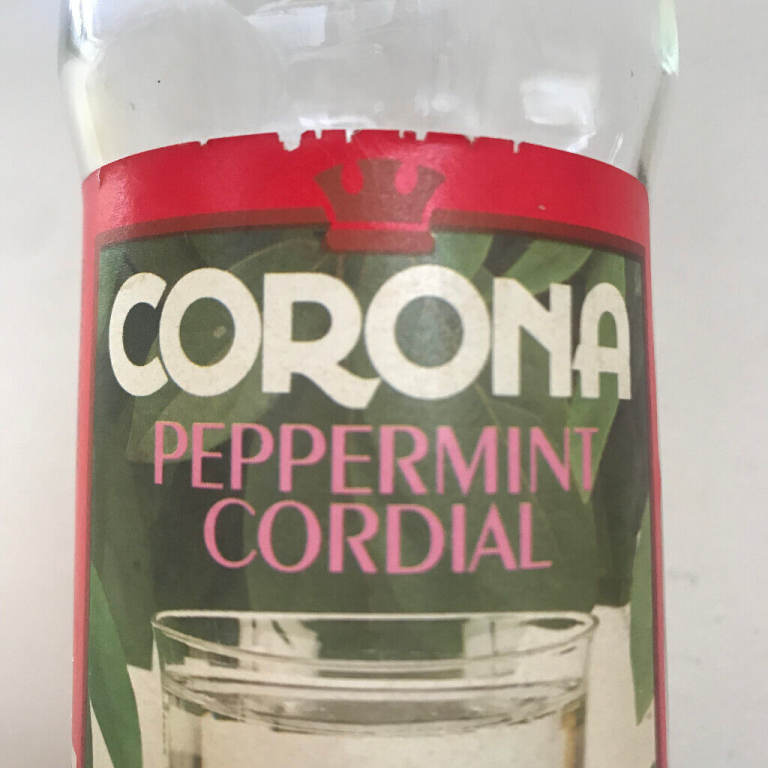 Vintage Corona Peppermint Cordial glass bottle + some contents.