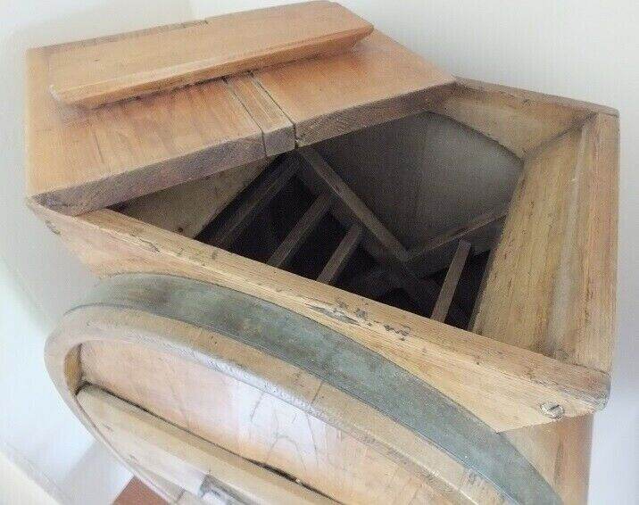 Antique butter churn with original handle and working paddles on its s