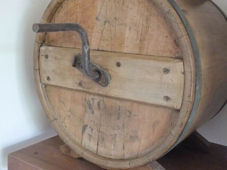 Antique butter churn with original handle and working paddles on its s