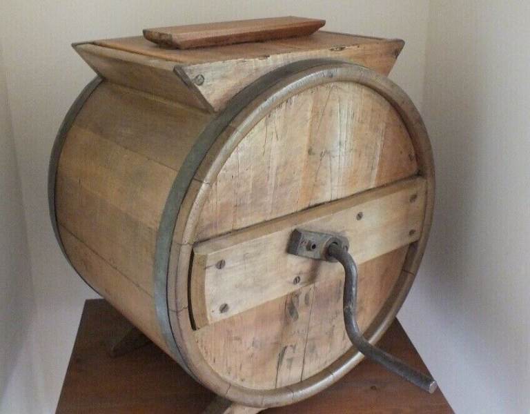 Antique butter churn with original handle and working paddles on its s