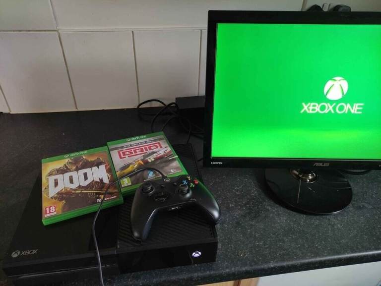 Xbox One console with Doom and Grid games