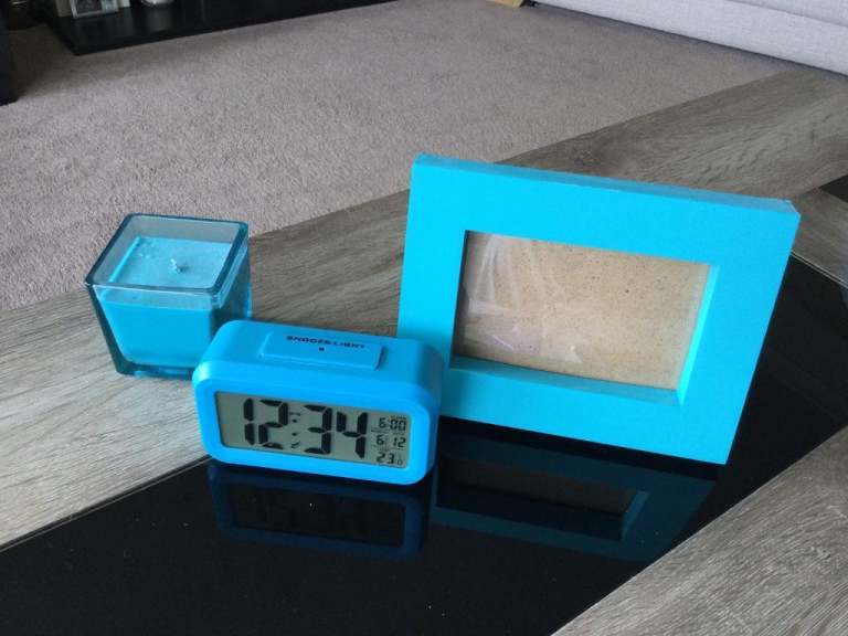 Collection of matching turquoise bedside table accessories.