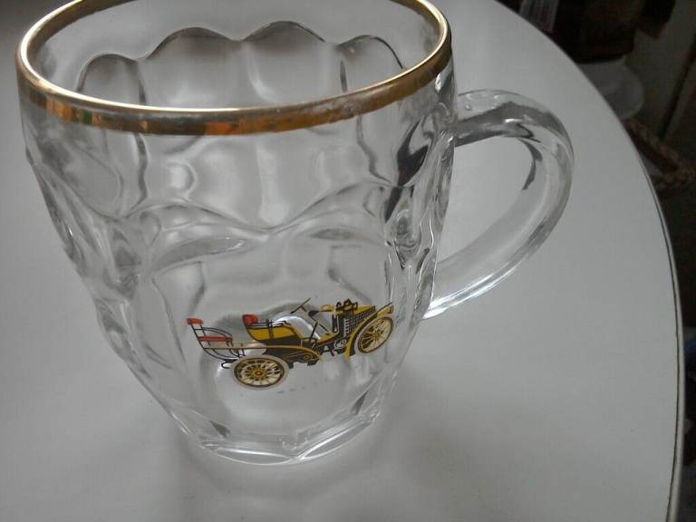 Vintage gold rimmed beer glass. Wolseley car image.