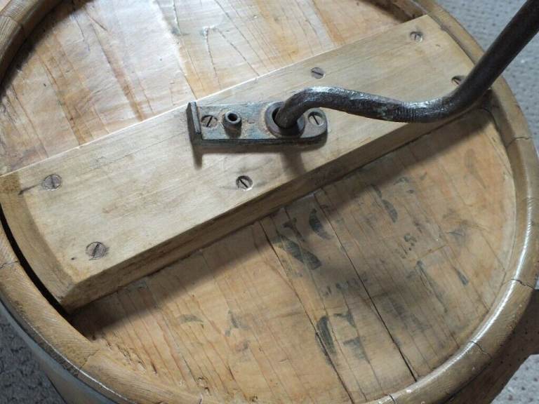 Antique butter churn with original handle and working paddles on its s