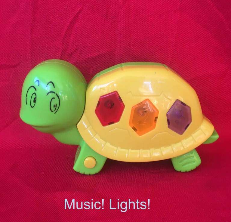 	Musical, flashing lights tortoise toy. Plays 3 tunes. Batteries included. Happy to post.