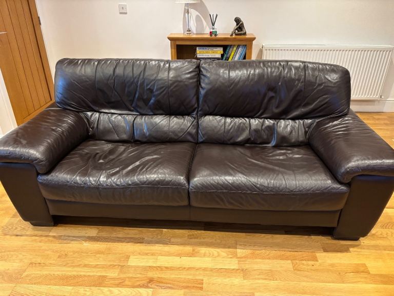Two three seater leather sofas and footstool 