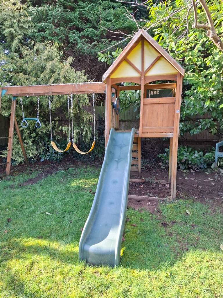 Climbing frame with slide and swings 