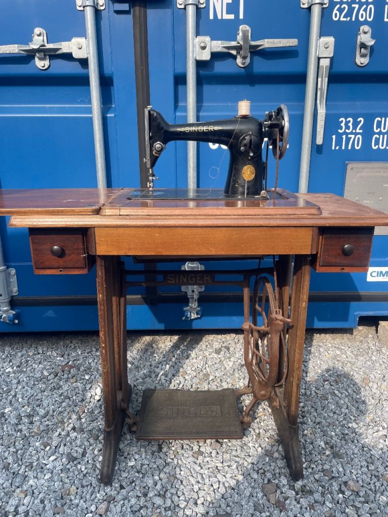 Selection of vintage sewing machines and Singer cast iron base