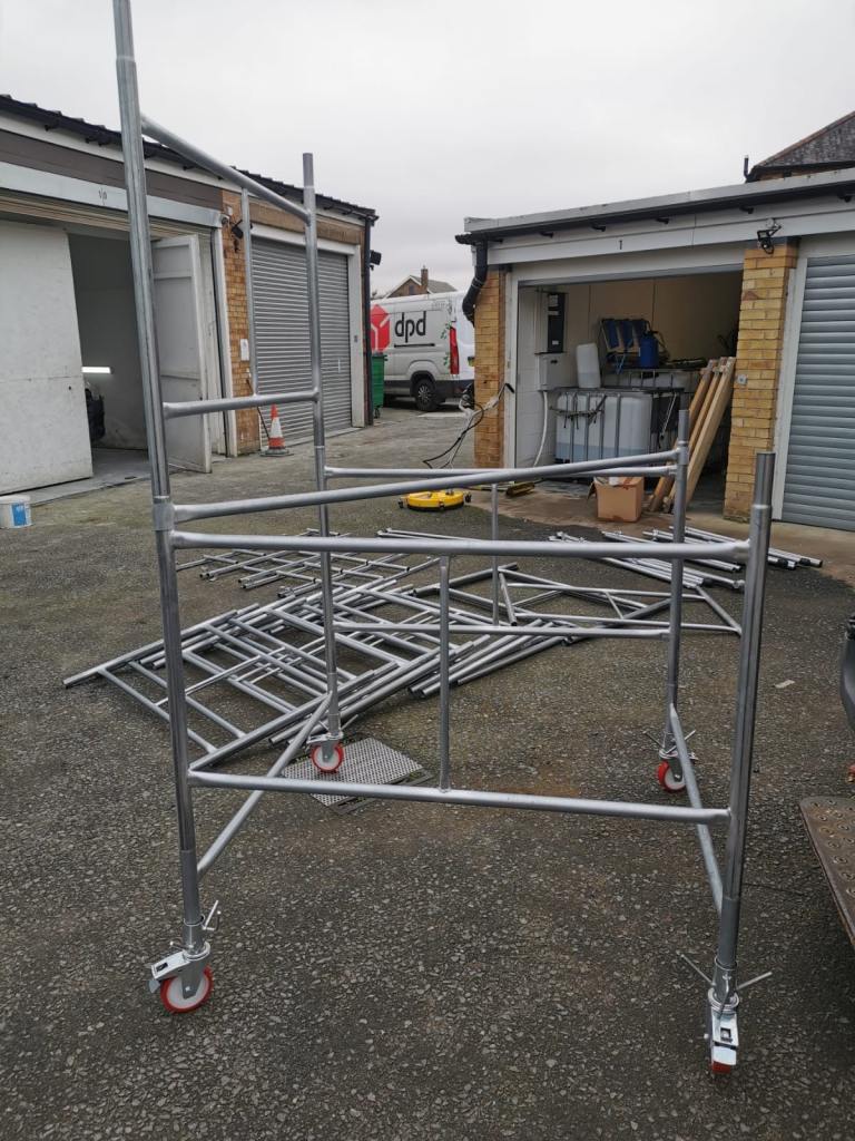 Scaffold tower, boards, trapdoor, ladder, adjustable bases 
