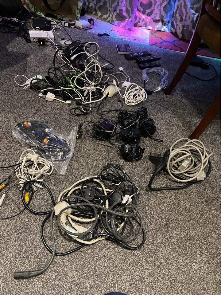 large collection of cables, power adapters, leads etc.