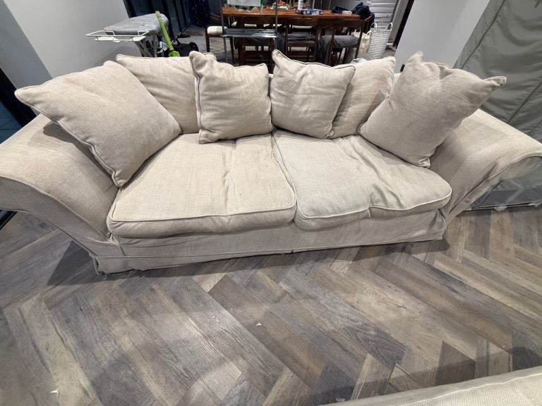 Large four seater grey fabric sofa 