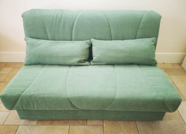 Green Fold-Out Sofa Bed with Pillows – Good Condition