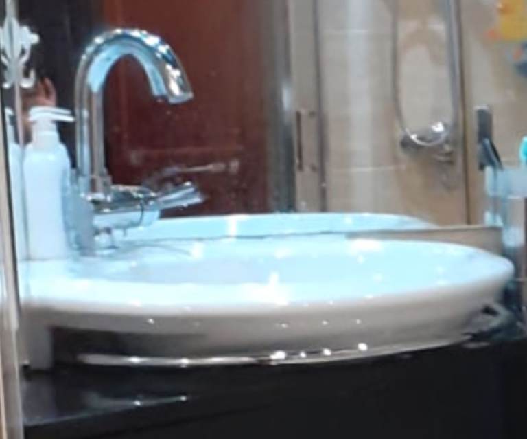 Corner white ceramic sink with towel holder