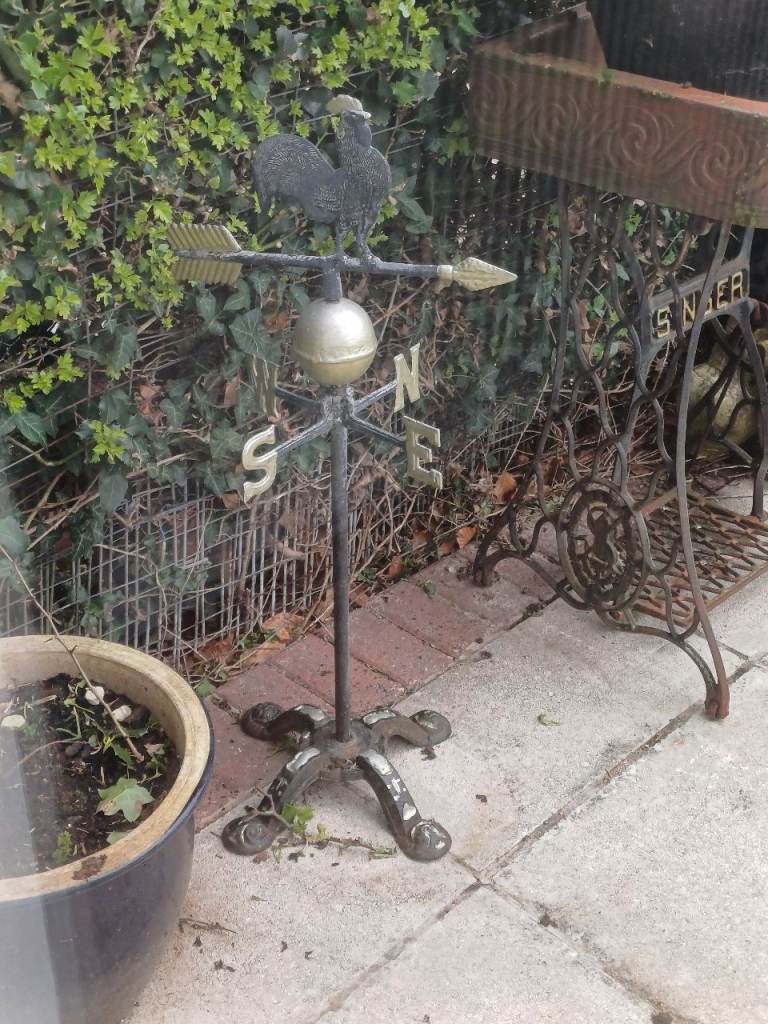 Antique weather vane on stand