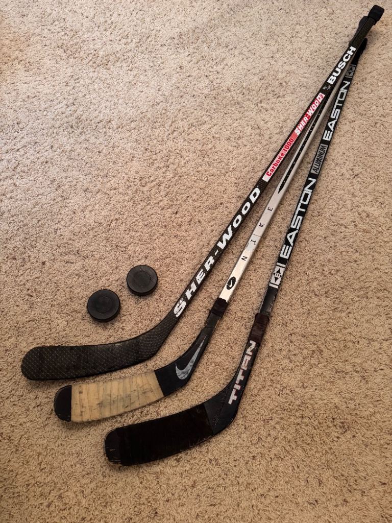 3 x right handed JUNIOR used ice hockey sticks NIKE, EASTON and BUSCH plus 2 plastic practice pucks