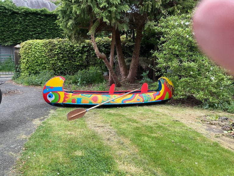 Fibreglass Canadian canoe with paddle. 3.4 metres long with 2 seats.
