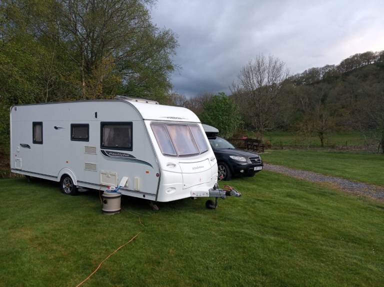 Coachman Pastiche 560 4 touring caravan 2010 with a fixed bed.