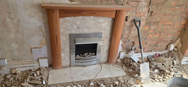 Electric fireplace with wood and marble surround