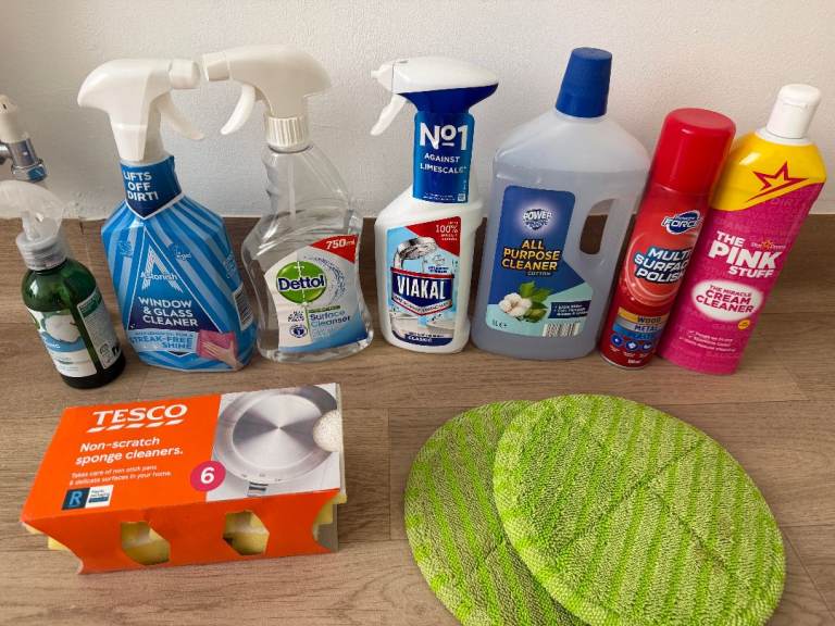 A bundle of brand new cleaning products, including various sprays and creams.
