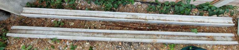 2 concrete fence posts