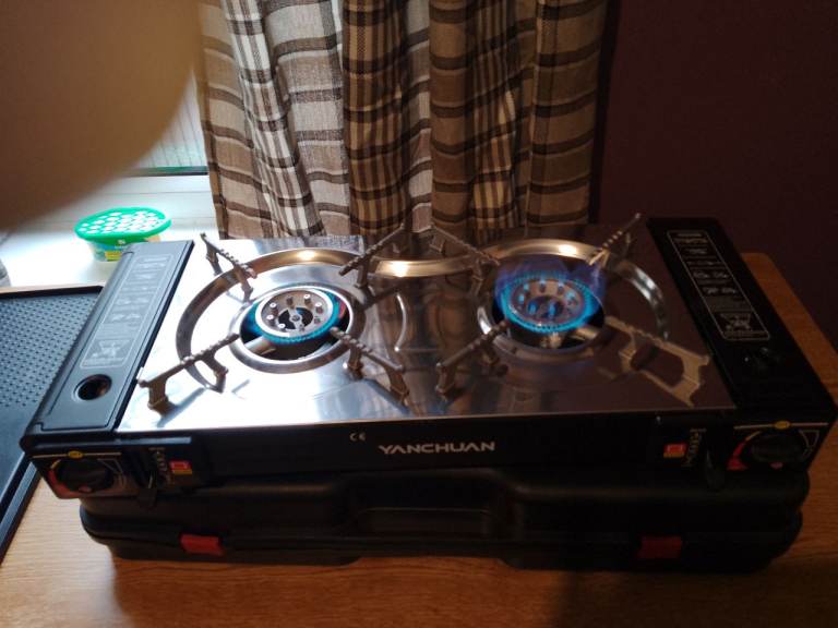 Brand New two burner cooker and 10 cans of gas