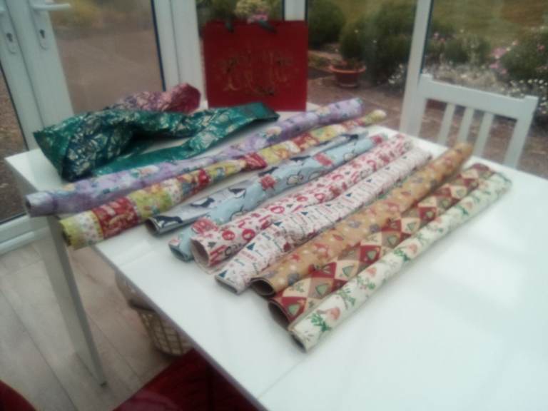 A bumper assortment of unused Christmas and other wrapping paper, and gift bag.