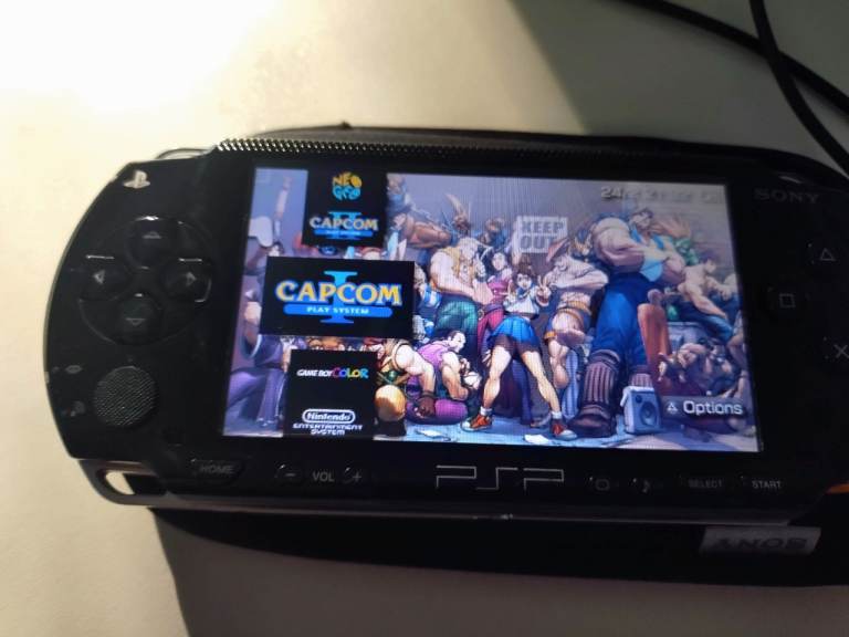 PSP 1003 with OSTENT battery, USB DATA cable & 64gb memory card.