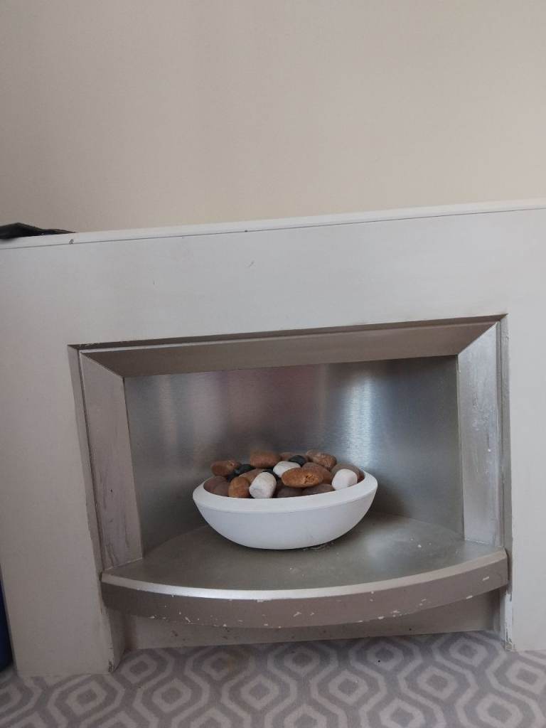 Modern White Fireplace Surround with Decorative Pebbles