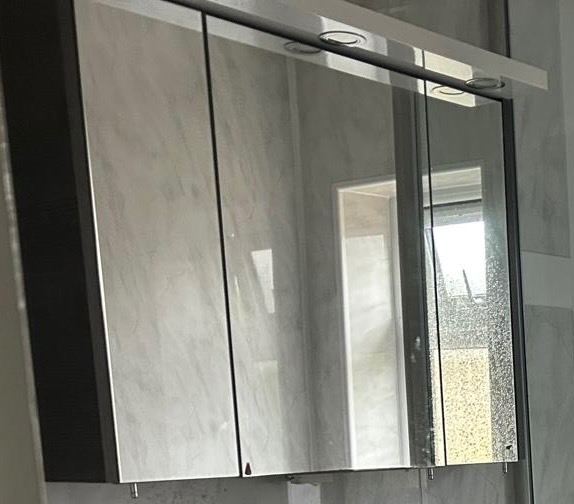 Stylish wall-mounted mirror cabinet with three doors