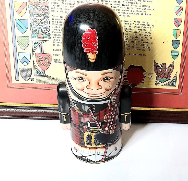 SCOTTISH PIPER LIDDED TIN - with BAGPIPES, SPORRAN etc 23 cm tall x 9 cm