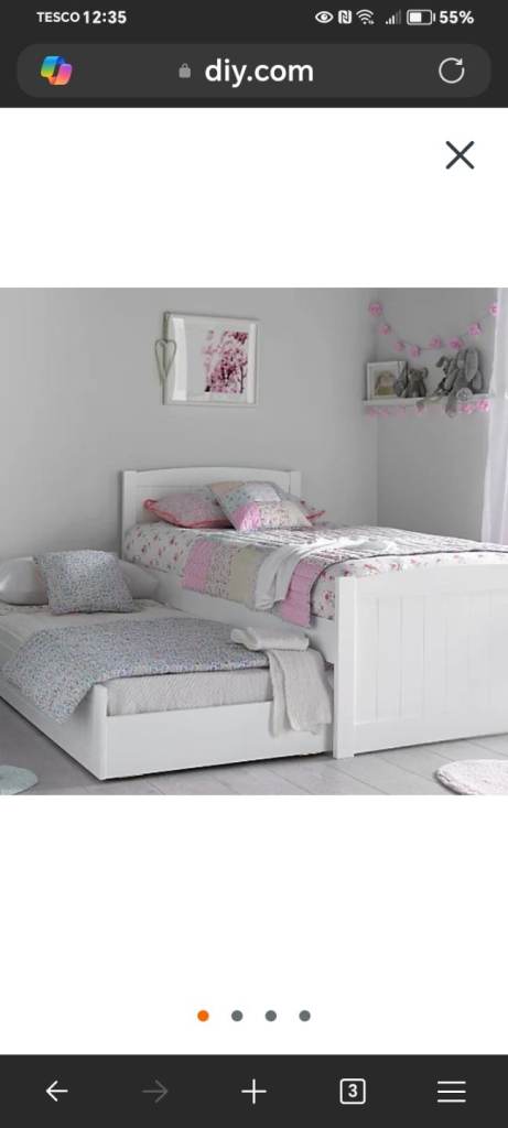 White wooden bed with sleepover under bed