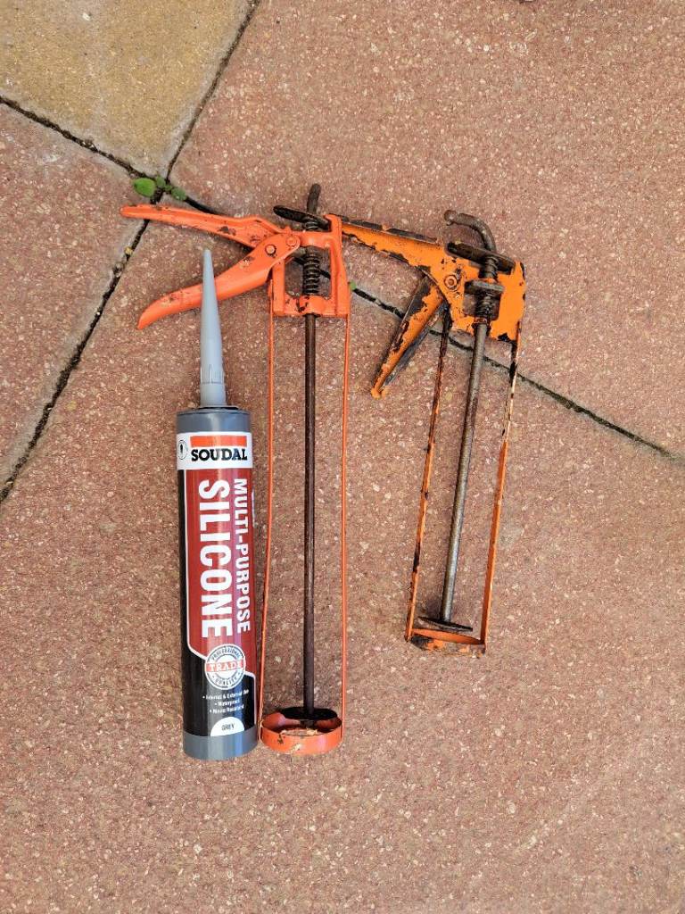 Grey silicone sealant unopened and guns.