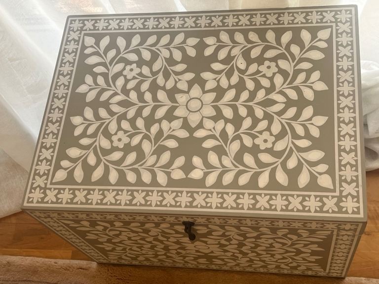 Carved treasure‑chest box with side handles and roomy storage. Simple, stylish, and versatile.