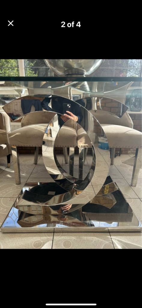 Glass dining room table with silver CC base