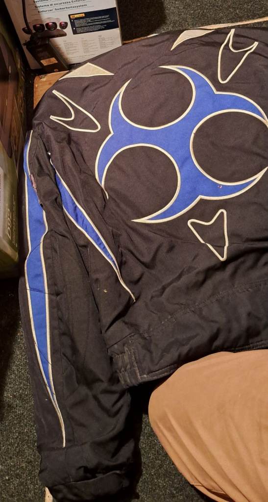 Various motorbike jackets, pants and items. 