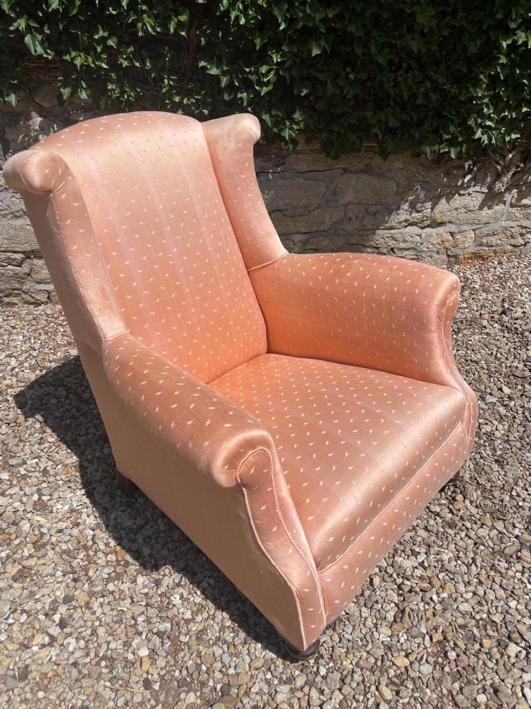 Wingback chair with rounded scroll homes and ring turned front legs