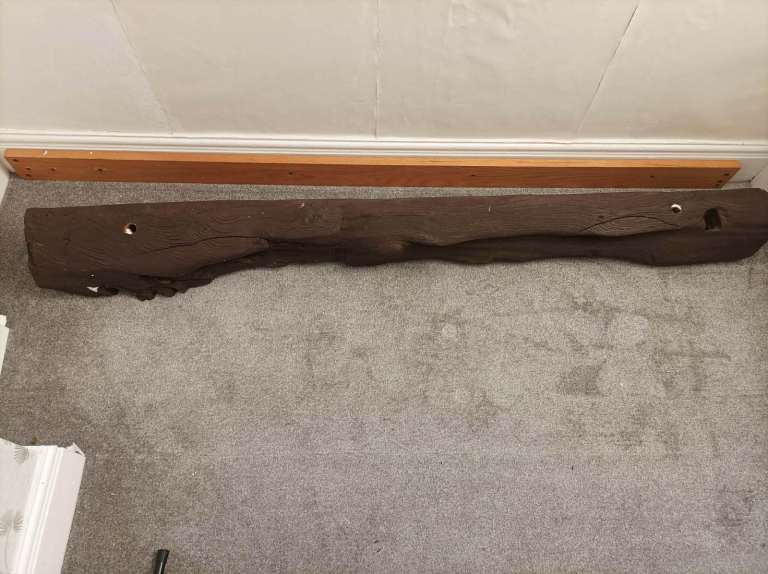 Dark-coloured rustic mantlepiece