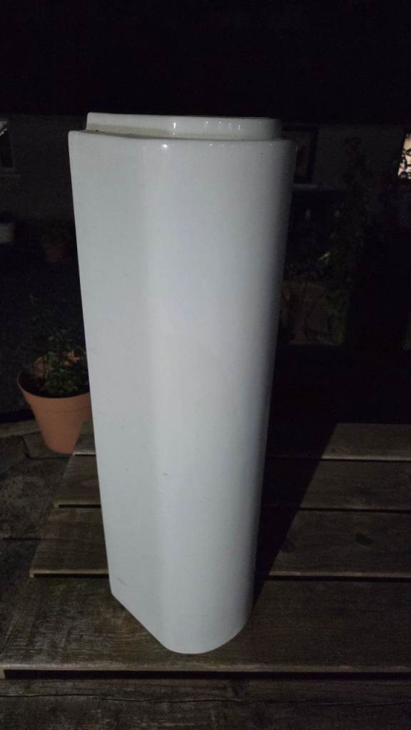 White ceramic sink pedestal