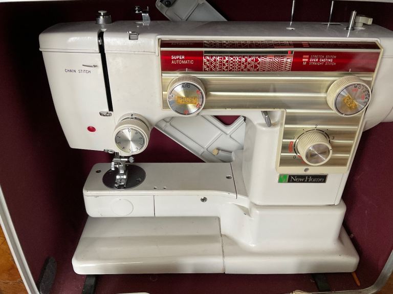 New Home Model 609Sewing Machine with Case ,manual and attachments.
