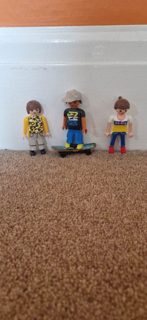 THREE PLAYMOBIL FIGURES. ONE WITH SKATEBOARD. EXCELLENT CONDITION.