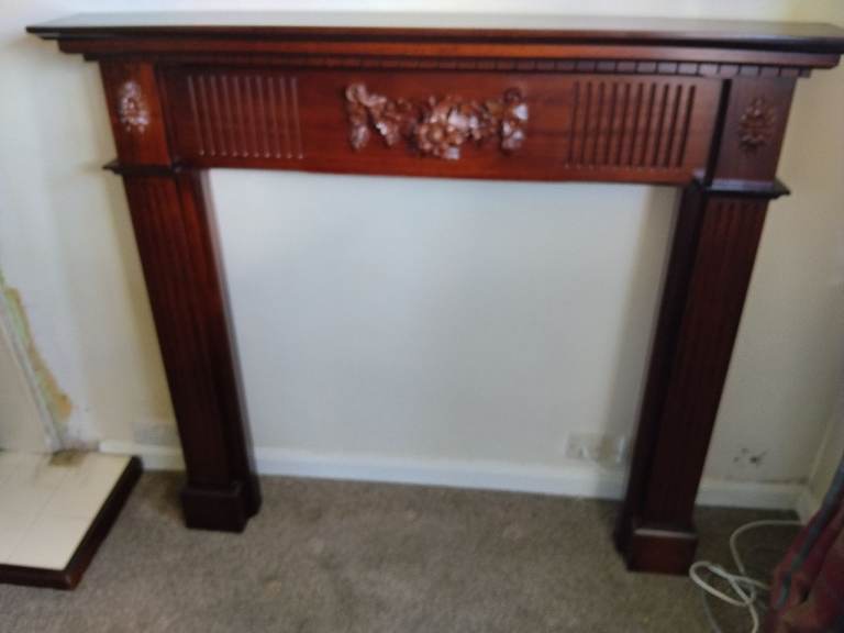  Dark Wooden Fireplace Surround with Carved Details