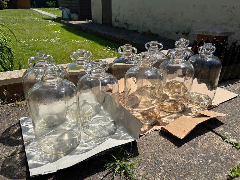 10 demijohns & 12 home brew beer bottles