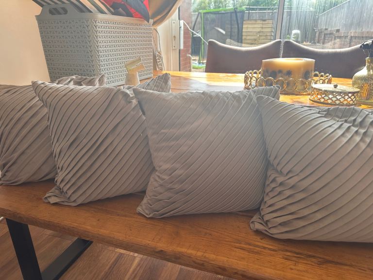 Four beige cushions