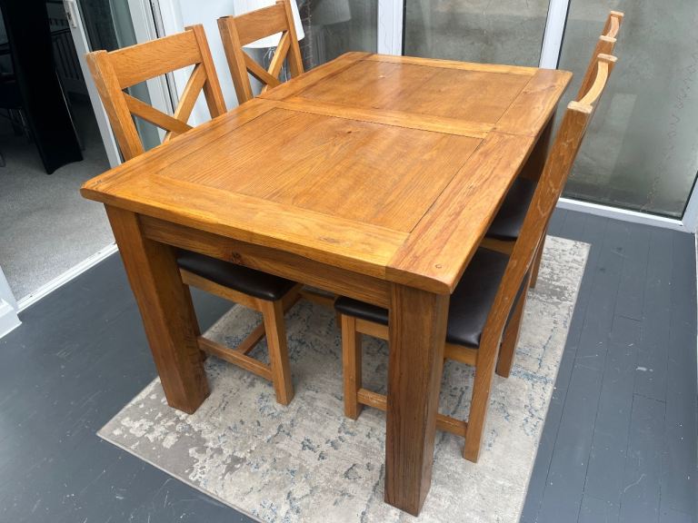Solid oak dining table and chairs 