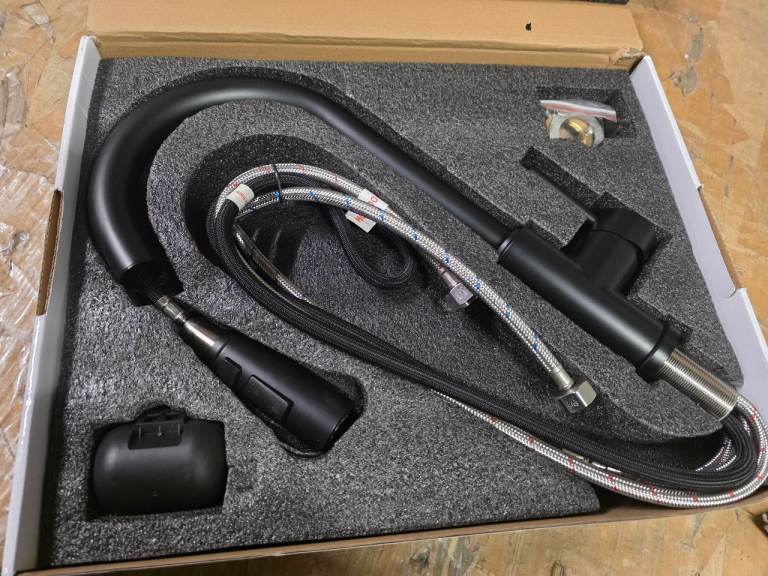 A new still boxed black finsh pull down kitchen tap with single handle and faucet .