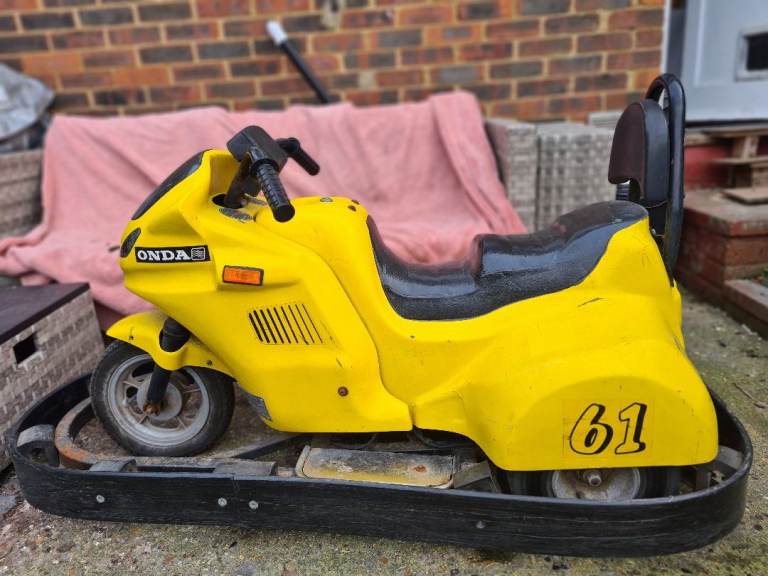 Childs electric motorbike with surrounding bumper
