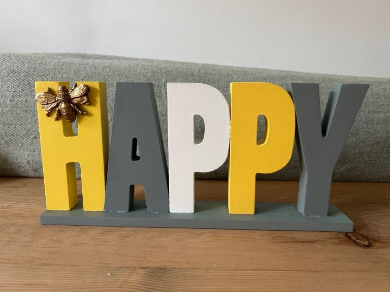 Yellow and grey happy sign 
